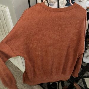 Rust color oversized sweater with even slit